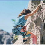 a woman climbing a rock